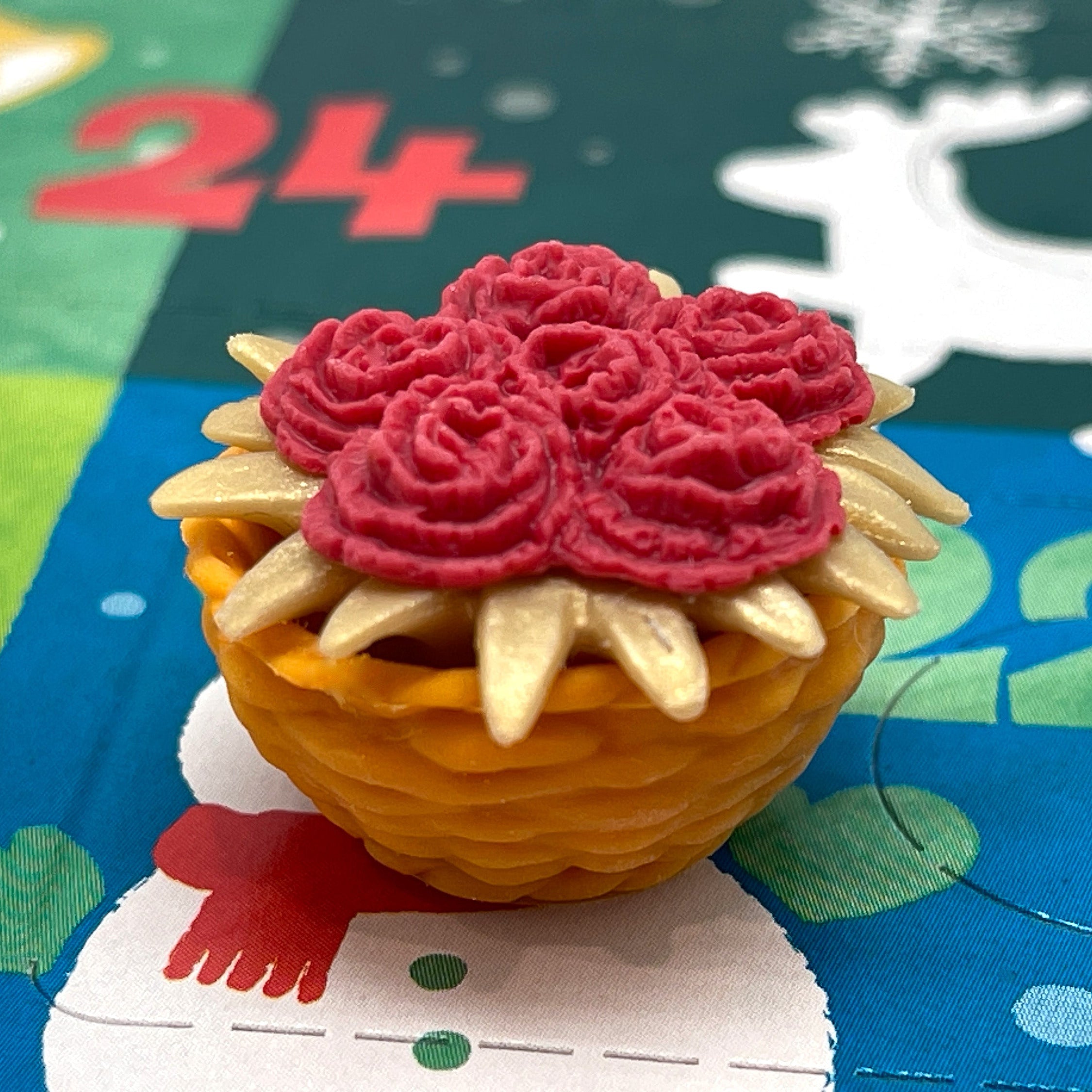 Red and gold flowers in a basket mini eraser on a colorful Christmas Advent Calendar