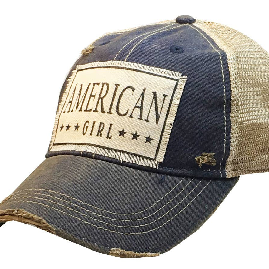 Blue baseball cap with American Girl patch on a white background
