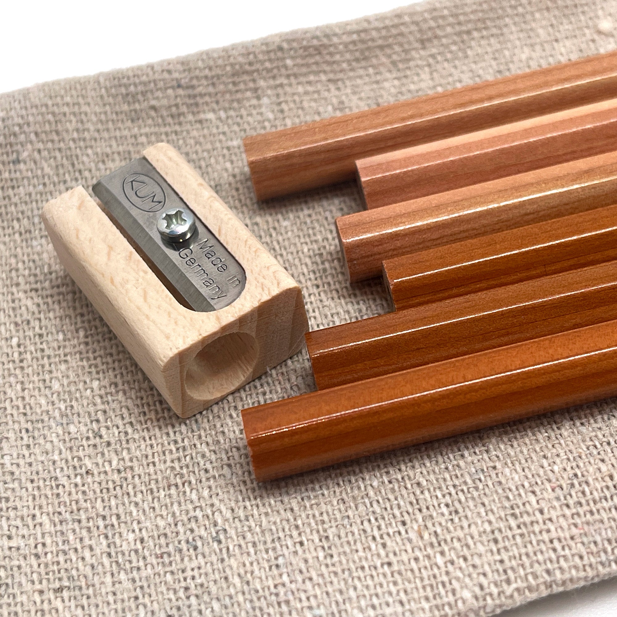 Camel HB graphite pencils with a sharpener on a textured surface