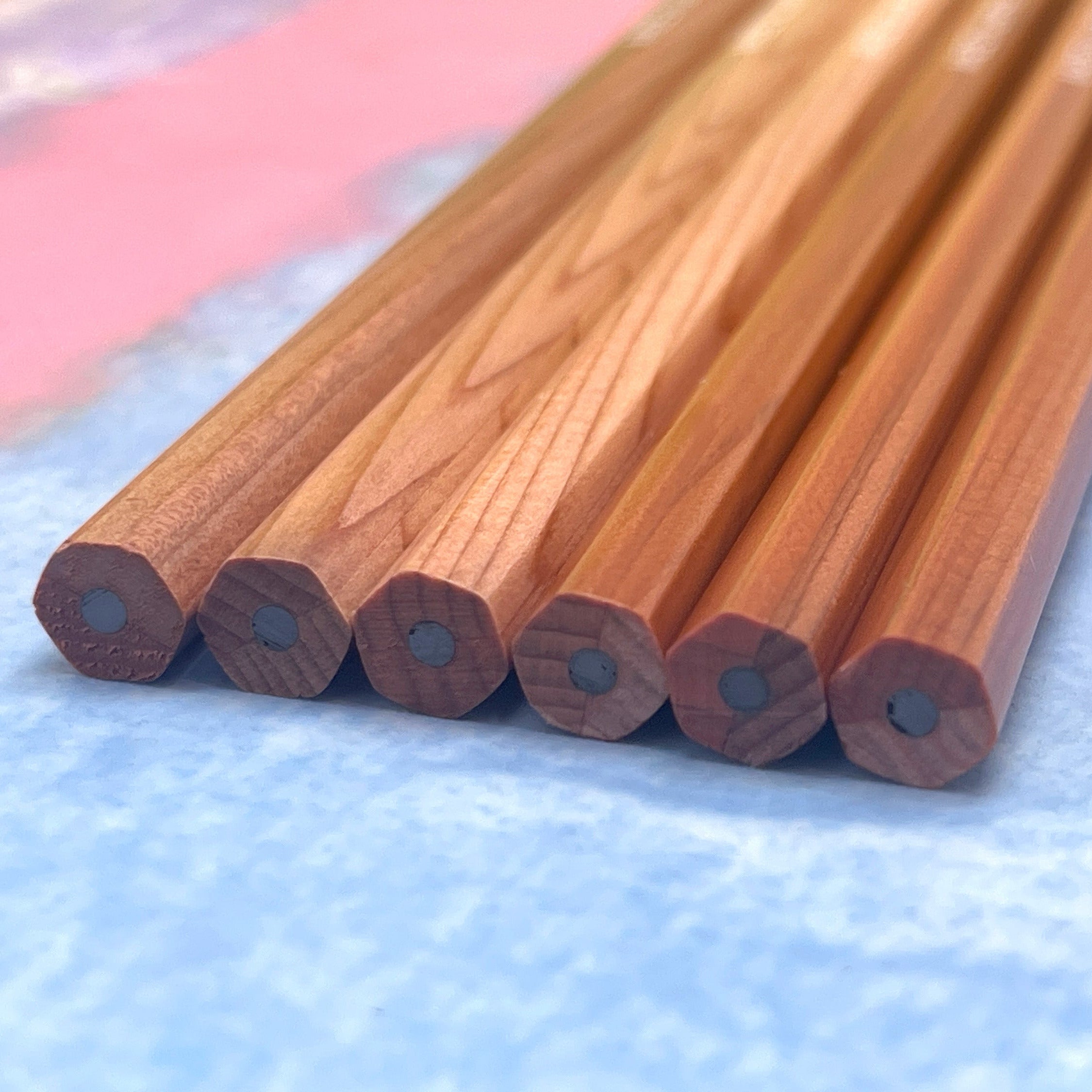 Wooden Camel HB Graphite pencils on a textured blue surface