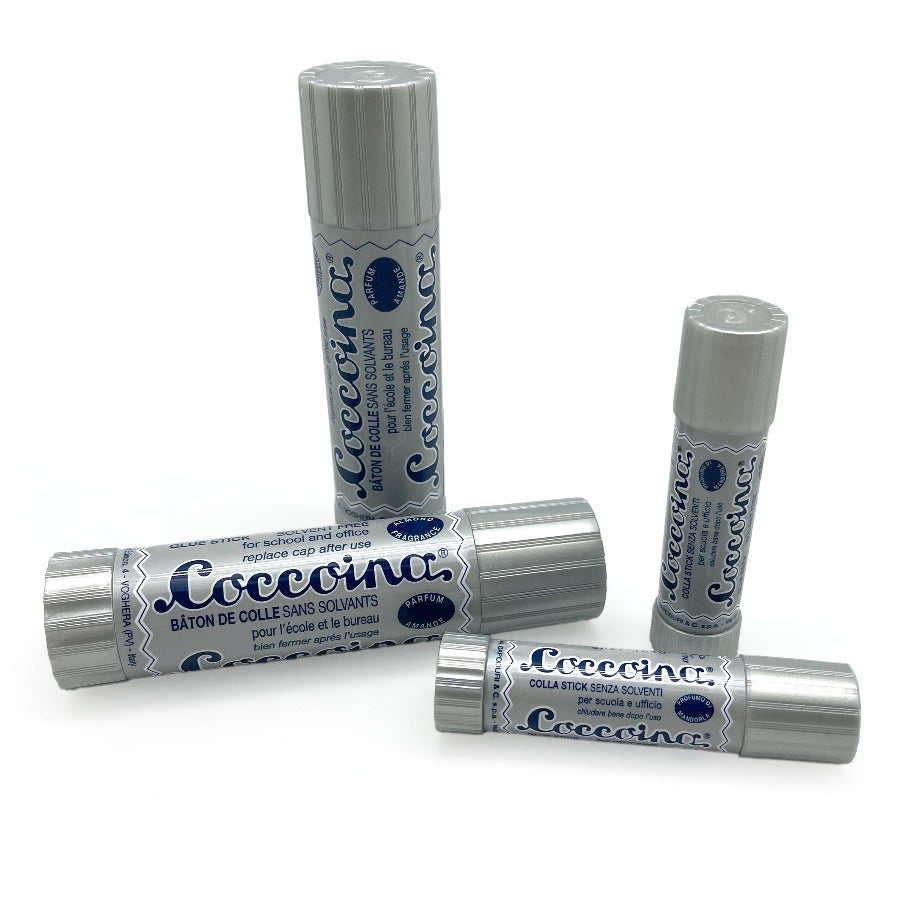Glue sticks jumbo and small sizes of coccoina against a white background