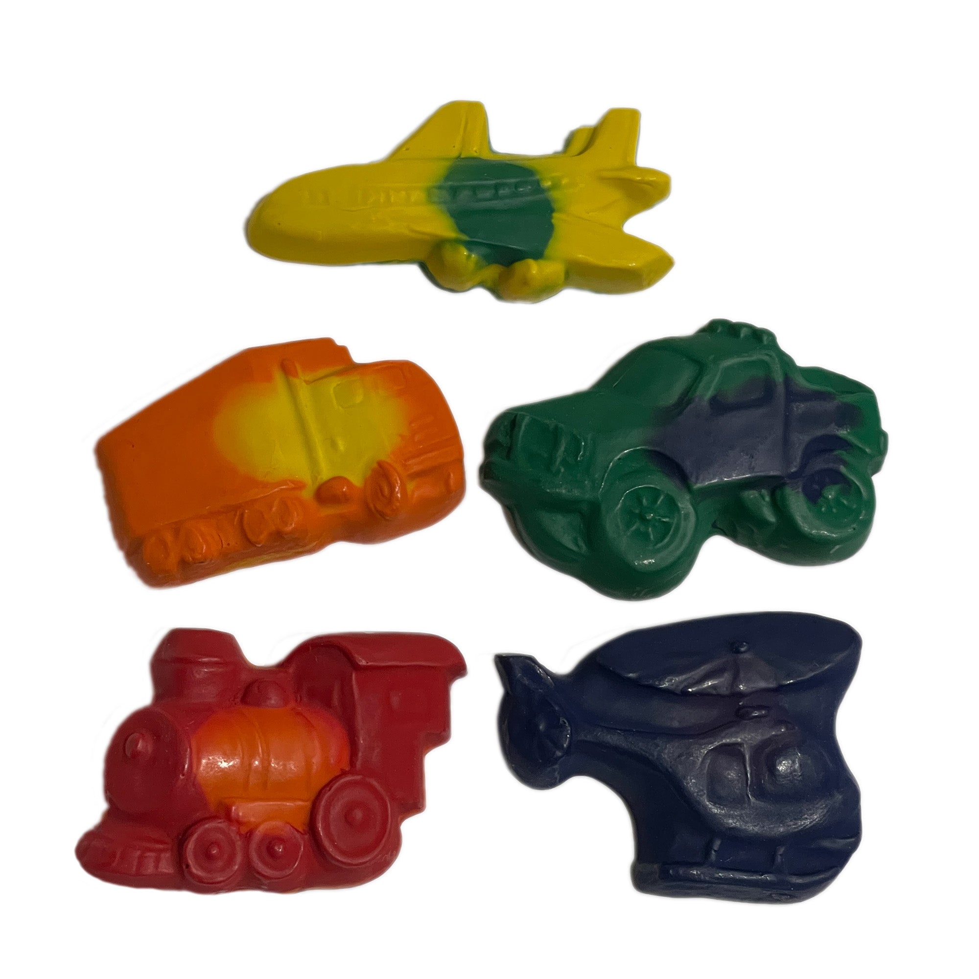 A set of multicolored crayons shaped like various transportation vehicles, including a plane, car, boat, train, and spaceship.