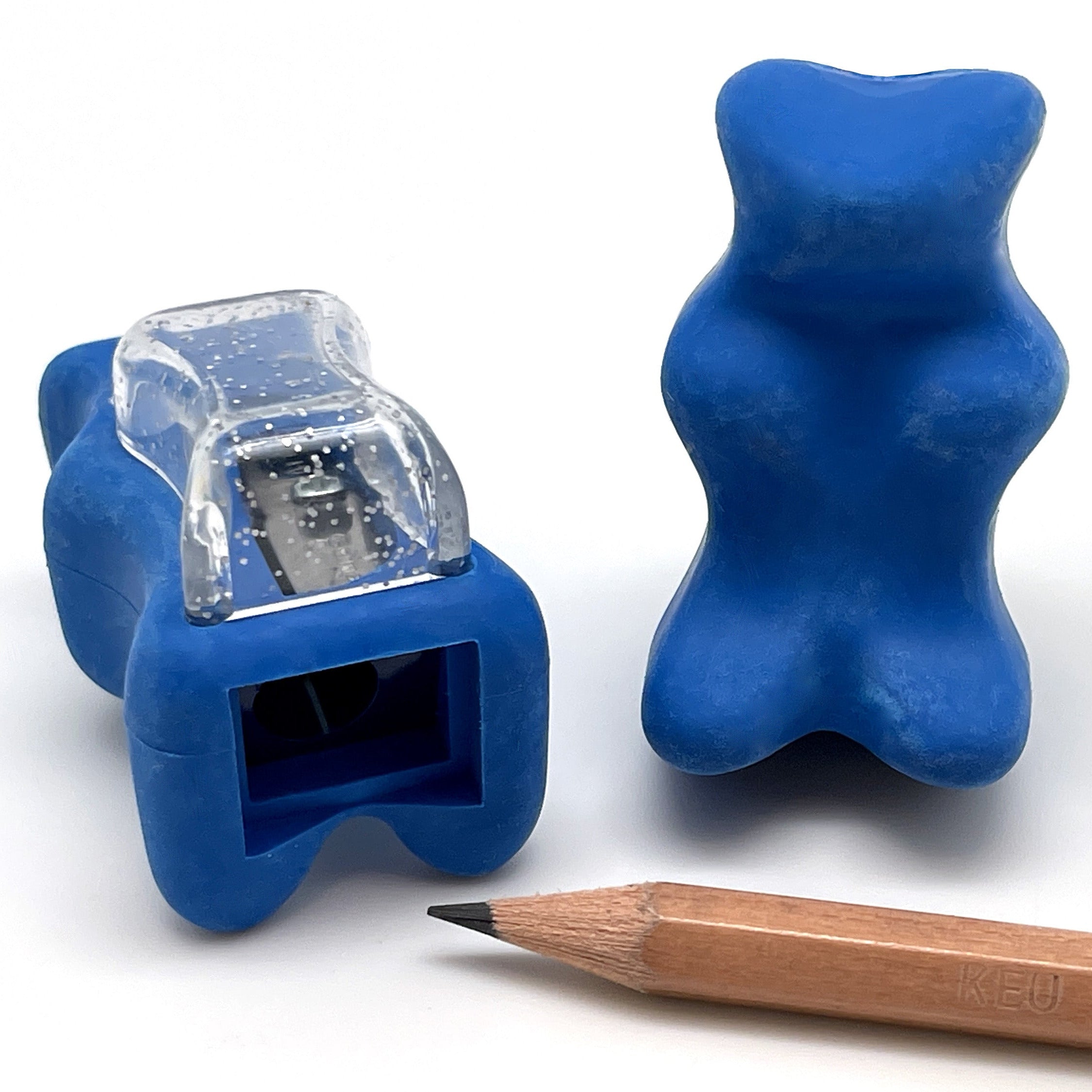2 blue gummy bear-shaped erasers with built in pencil sharpener next to a wooden pencil on a white background