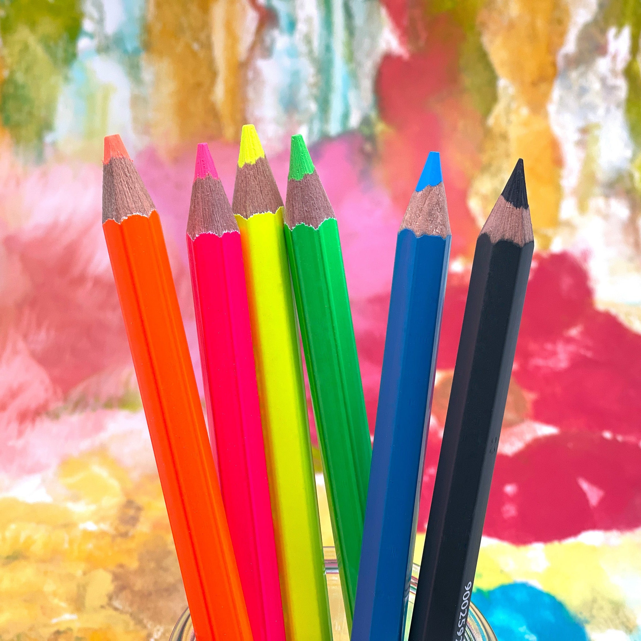 Set of colorful jumbo size pencils against a colorful abstract background