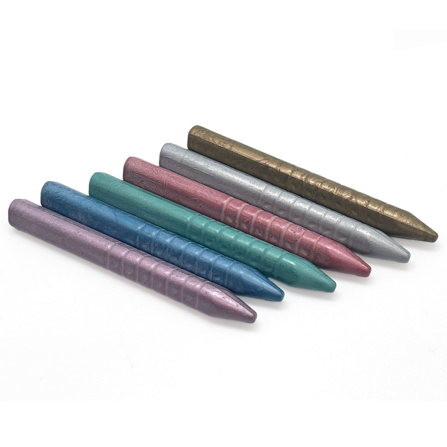 Triangular crayons made from metallic wax 6 colors on a white background