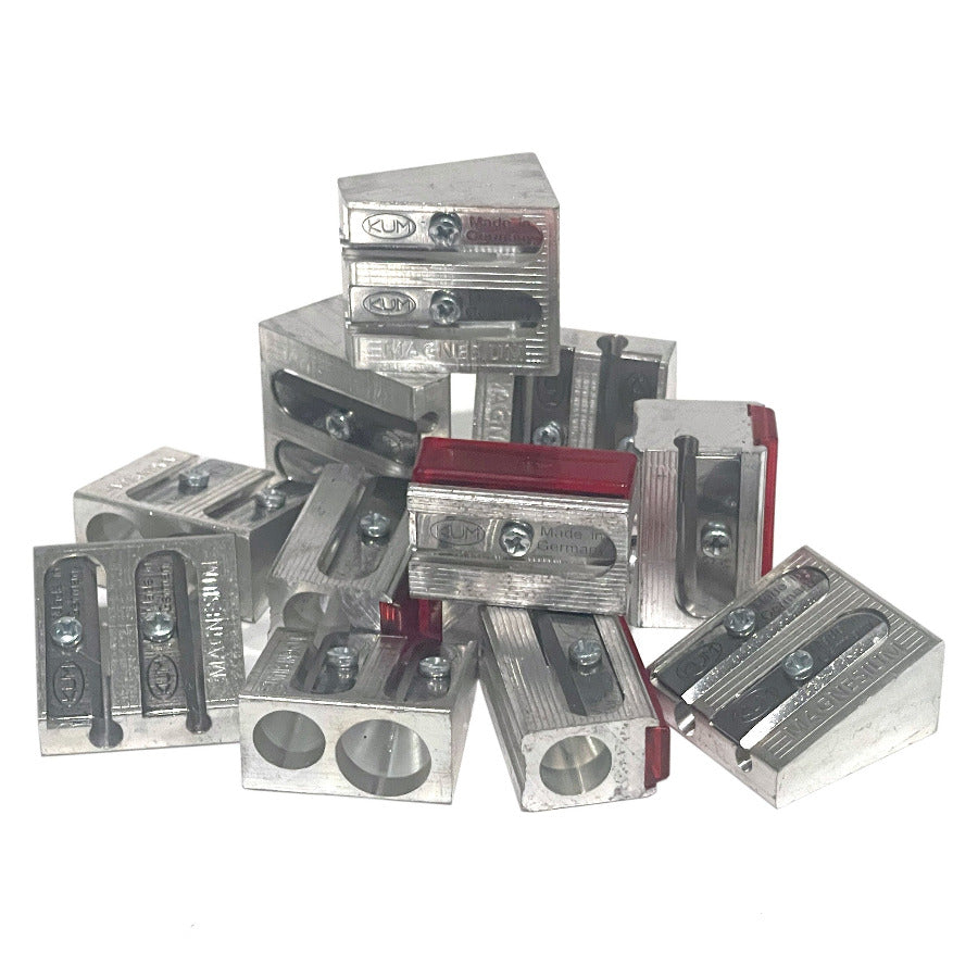 Collection of small pencil sharpeners made from metal magnesium alloy on a white background