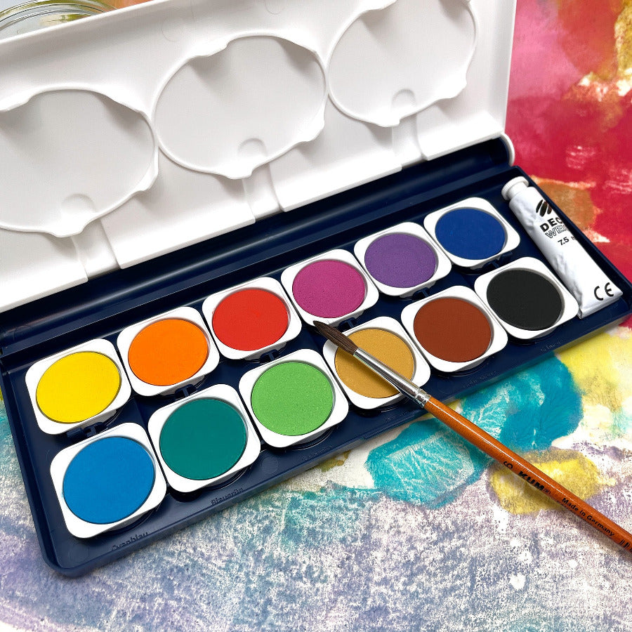 Watercolor paint box with 12 colors of paint and a paint brush against a colorful background