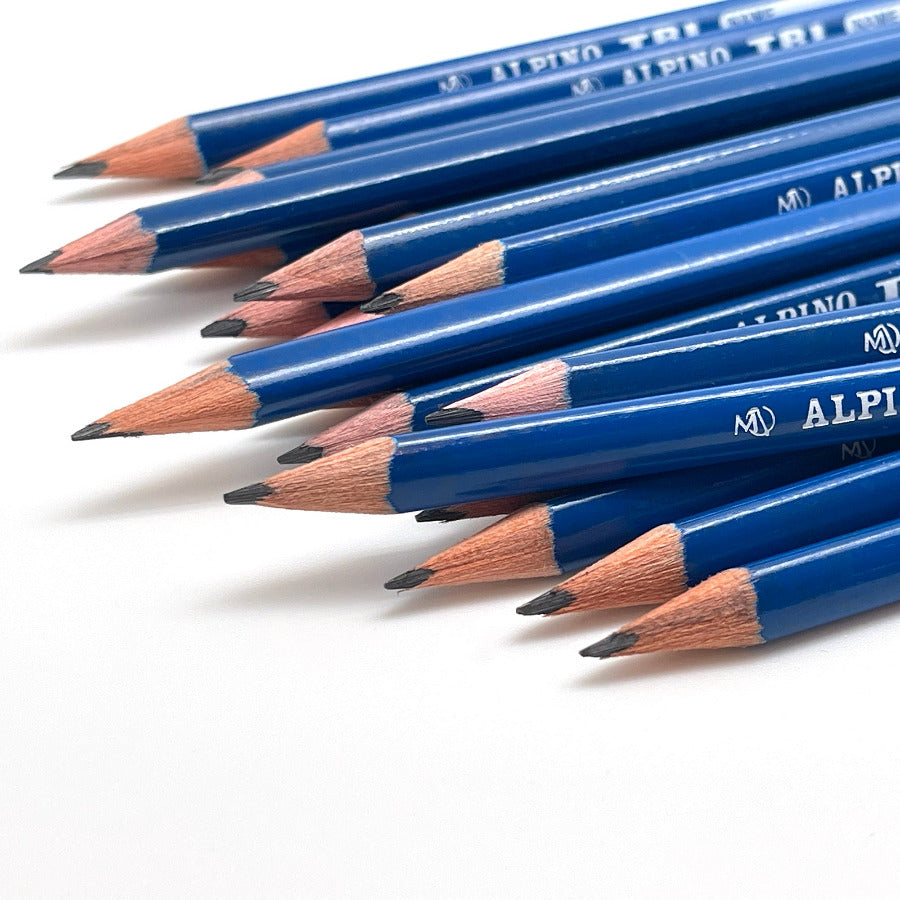 A close-up of several blue Alpino Tri graphite drawing pencils with exposed wood tips, arranged diagonally on a white background.