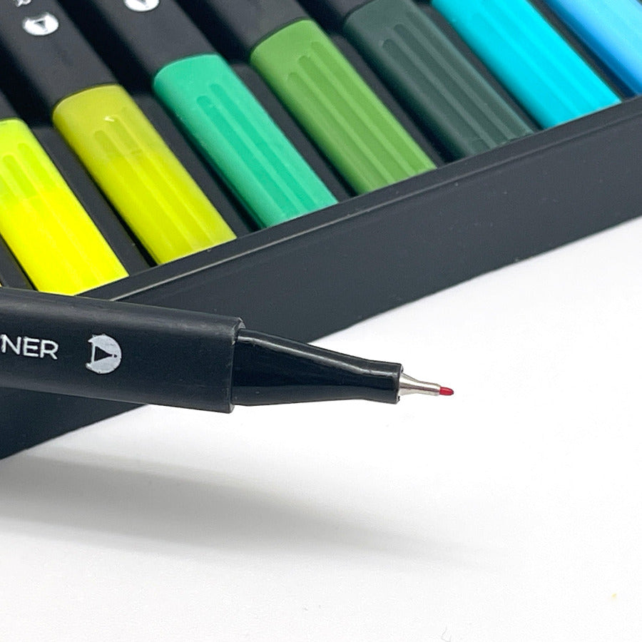 Close up of red fine liner pen with other colored duo tip markers in the background