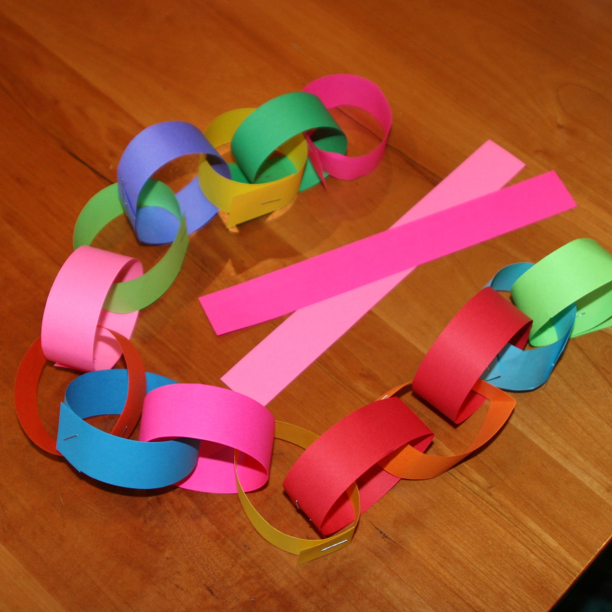 Colorful paper chain on a wooden surface