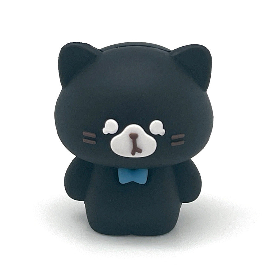 A small black cat pencil sharpener with a white snout, pink inner ears, and a light blue bow tie, centered on a plain white background.