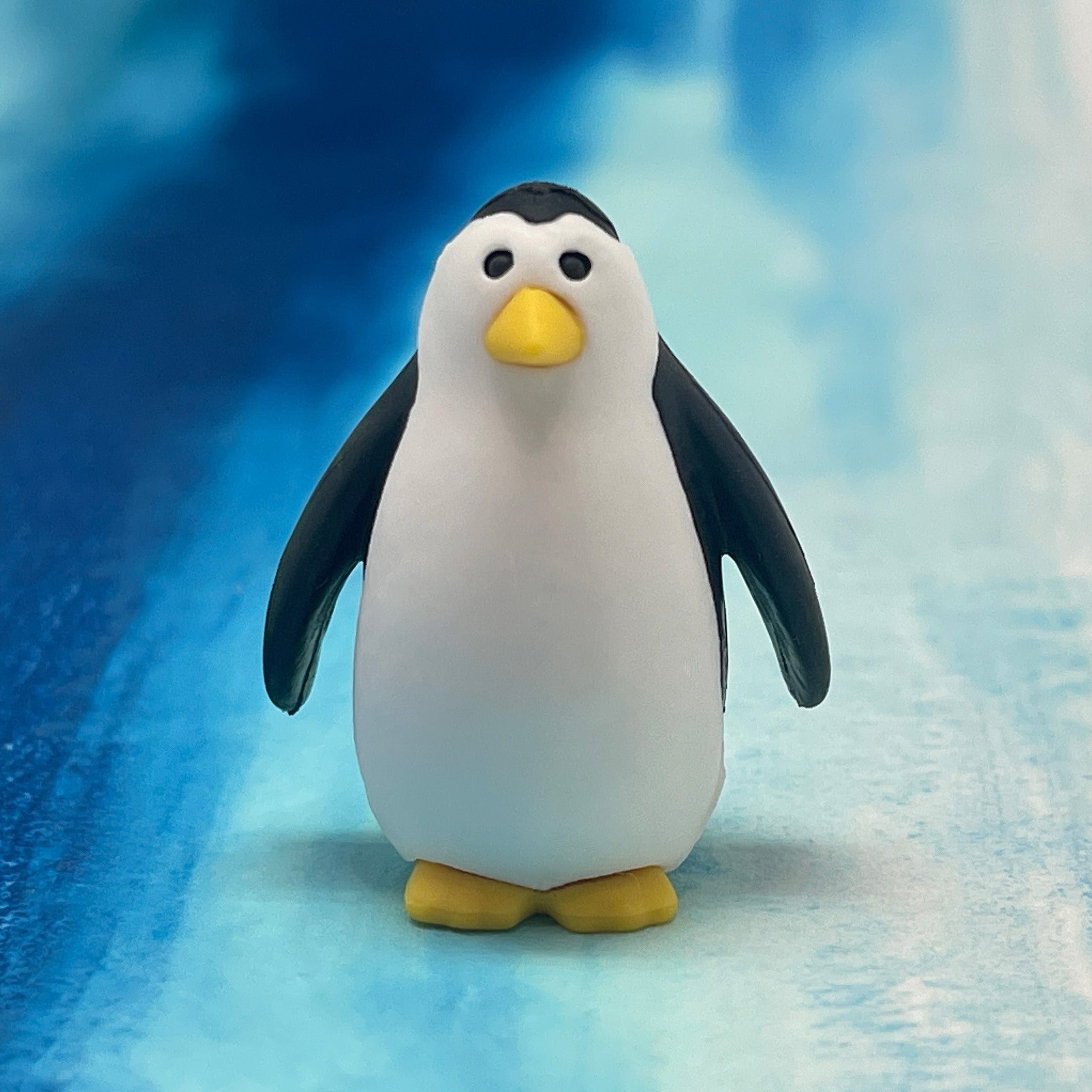 Penguin eraser on a blue and white textured background