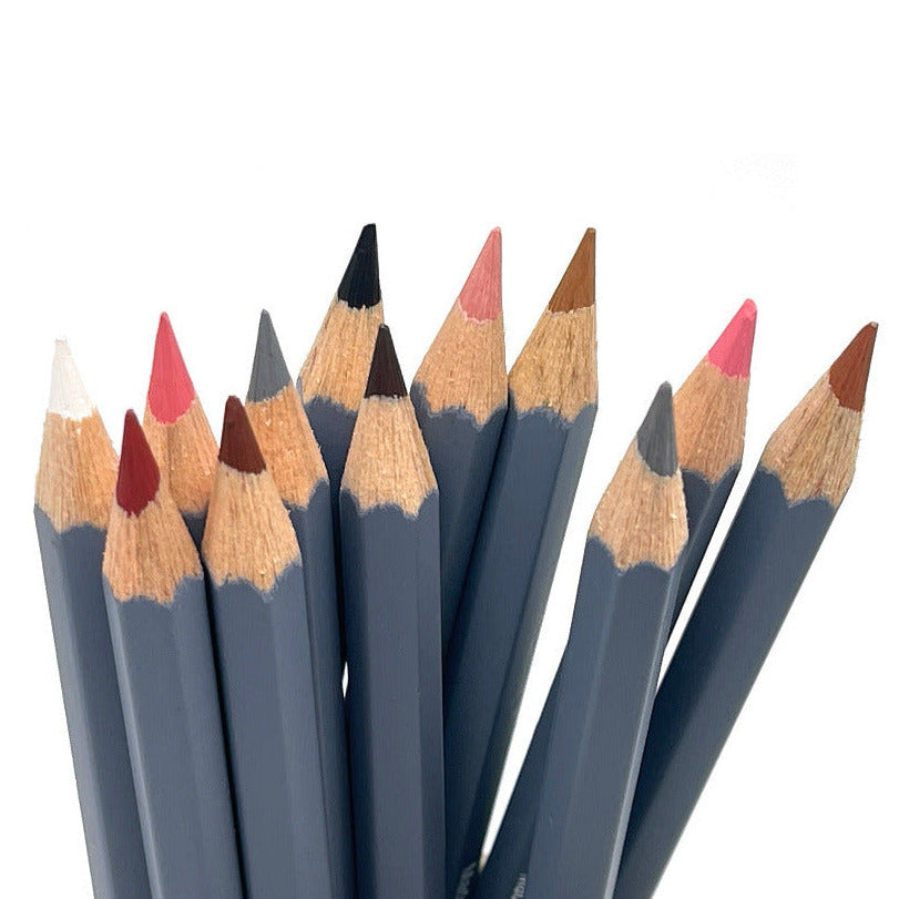 Set of 12 skin tone colored watercolor pencils against a white background