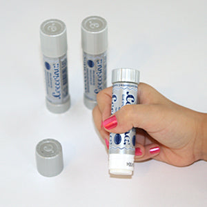 Child hand holding a glue stick with eco friendly lue