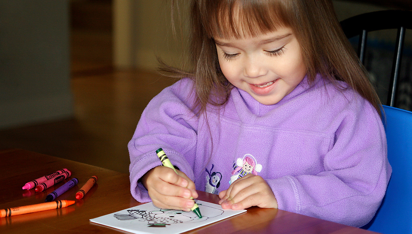 Young, happy child coloring a thank you card