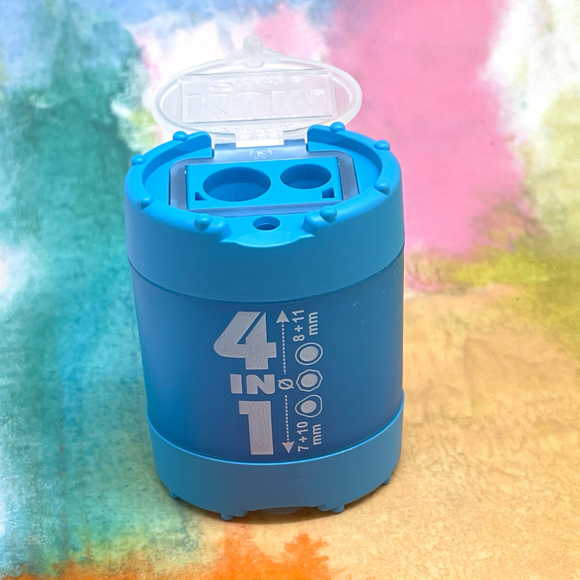 Blue pencil sharpener with a transparent lid on a colorful, blurred background
