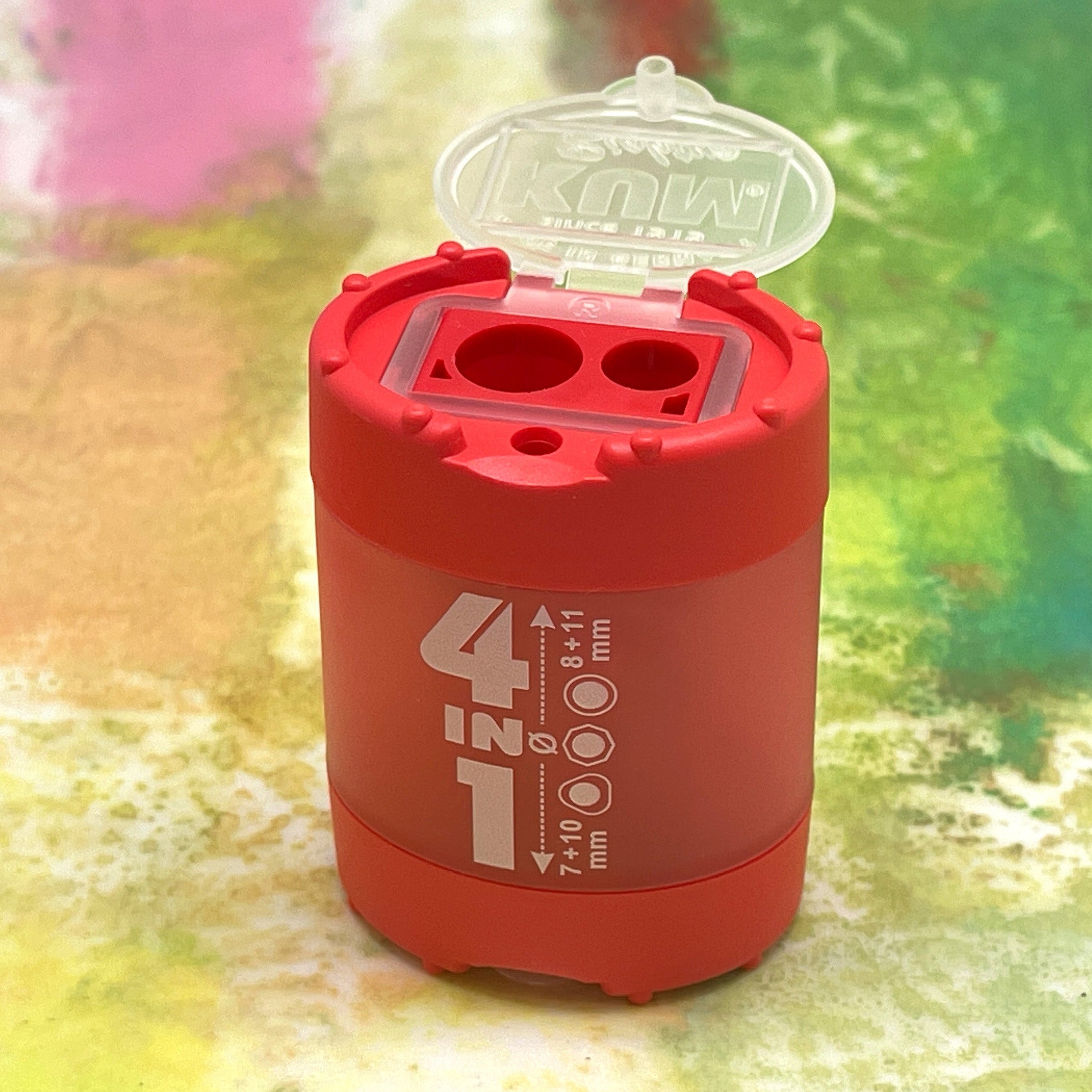 Red pencil sharpener with '4 in 1' branding on a colorful background
