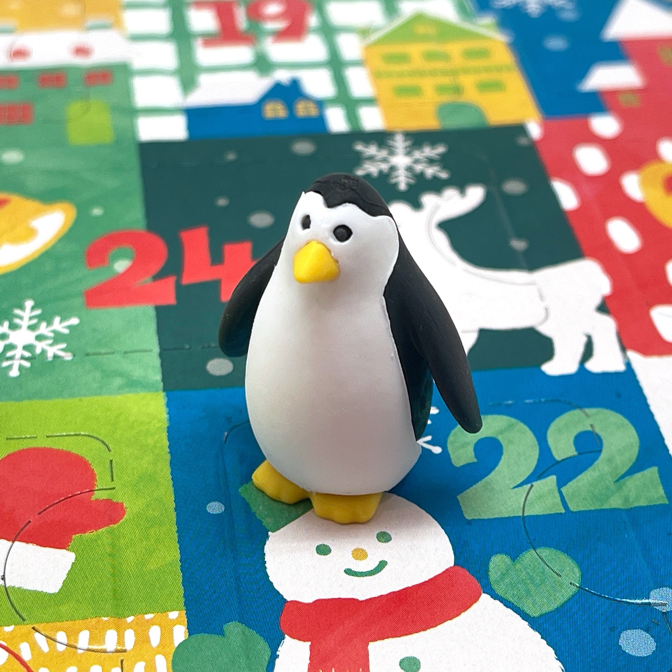 Black and white penguin mini eraser on a colorful Christmas Advent Calendar