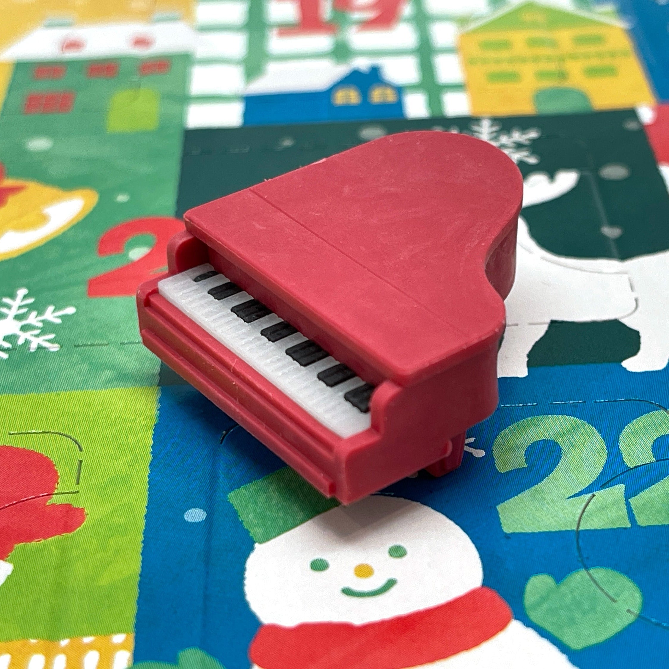 Red piano mini eraser on a colorful Christmas Advent Calendar
