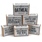 Stack of natural soaps in box packaging against white background