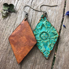 Front and back photo of hand crafted turquoise leather dangle earrings on a wooden surface.