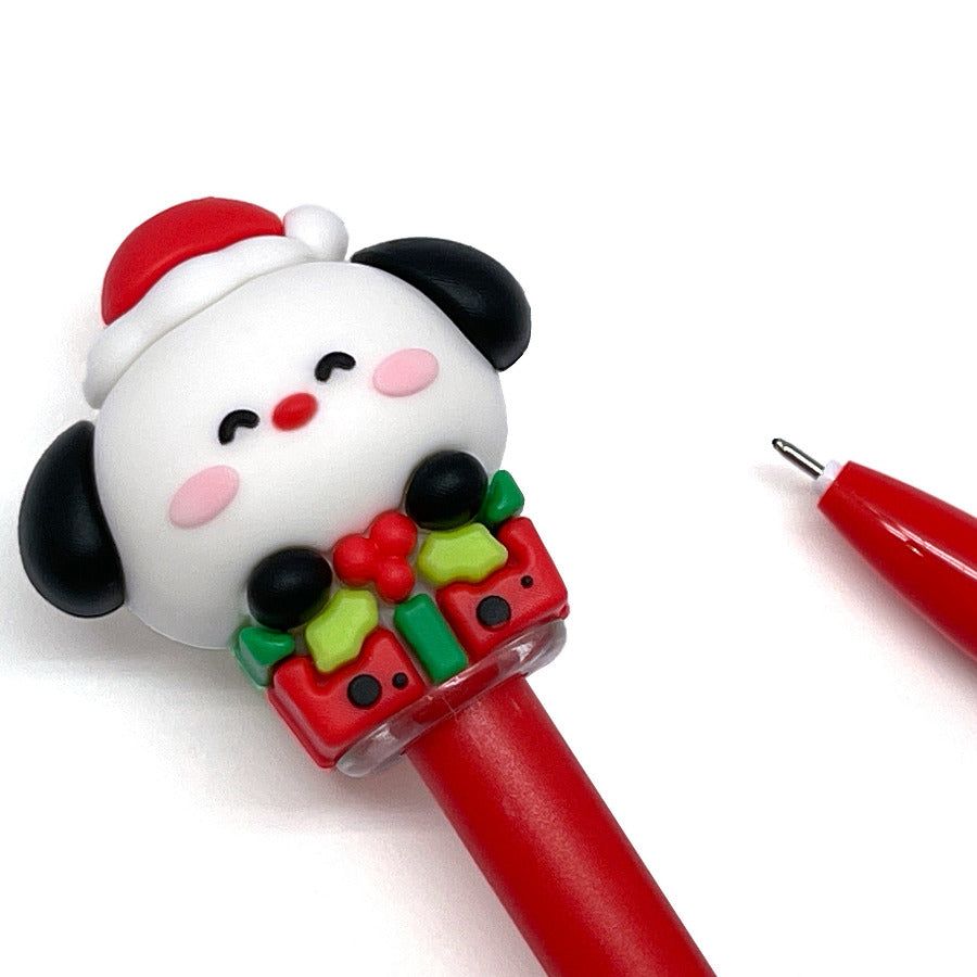 Red gel pen with a Christmas-themed cap of a dog wearing a Santa hat on a white background