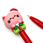 Red gel pen with a pink cat-shaped Christmas-themed pen cap on a white background
