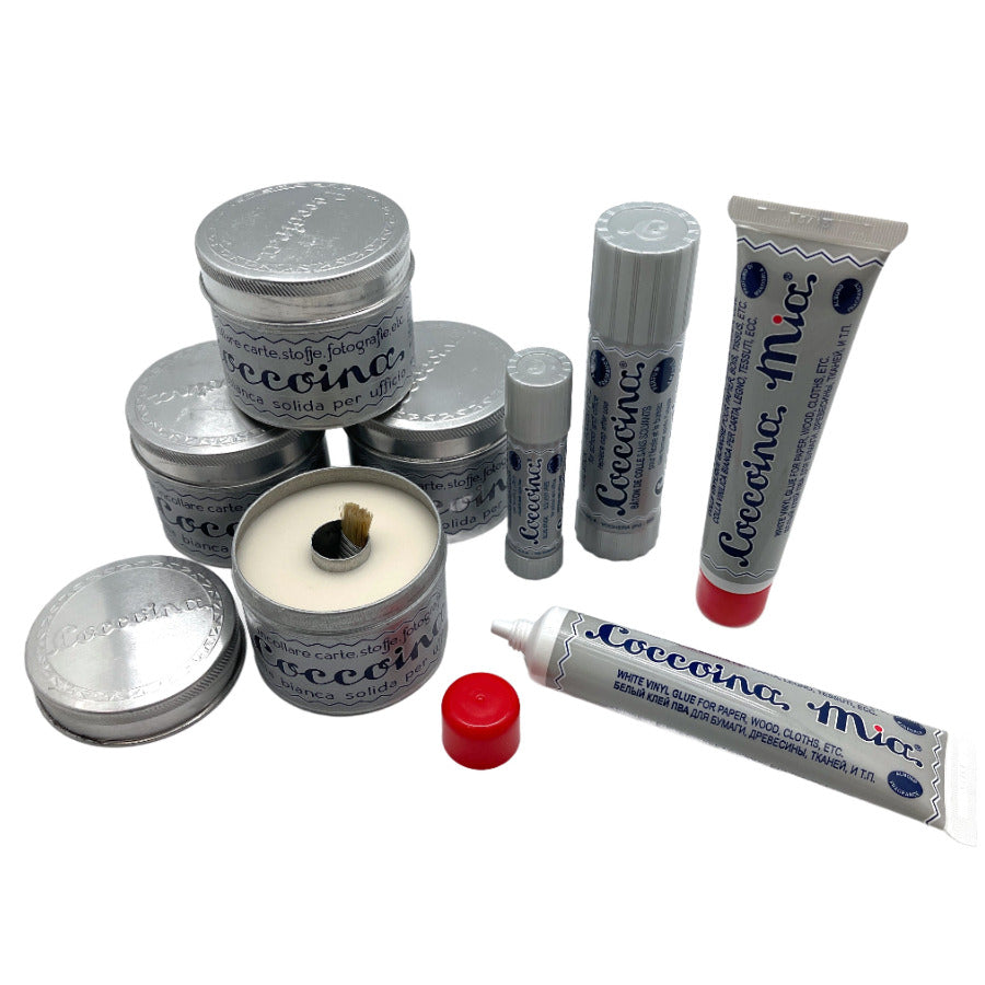 Coccoina is non-toxic glue made from potato starch in a variety of applications, including glue sticks, liquid glue, paste tins and more on a white background.