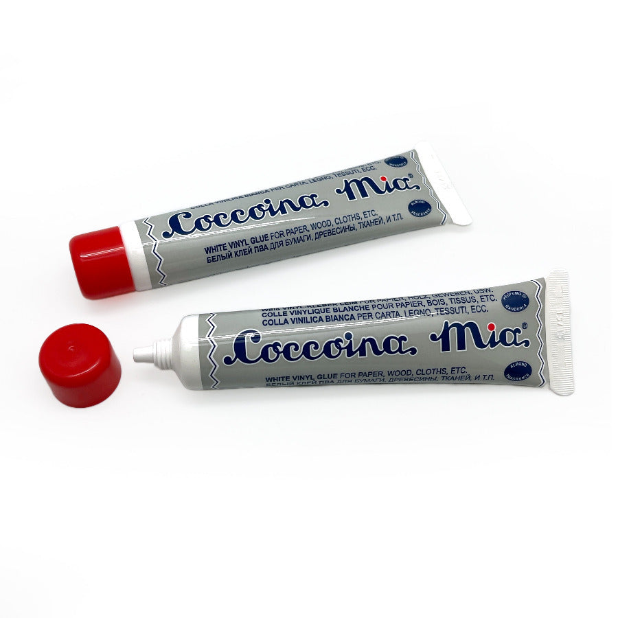 two tubes of coccoina Mia white glue against a white background