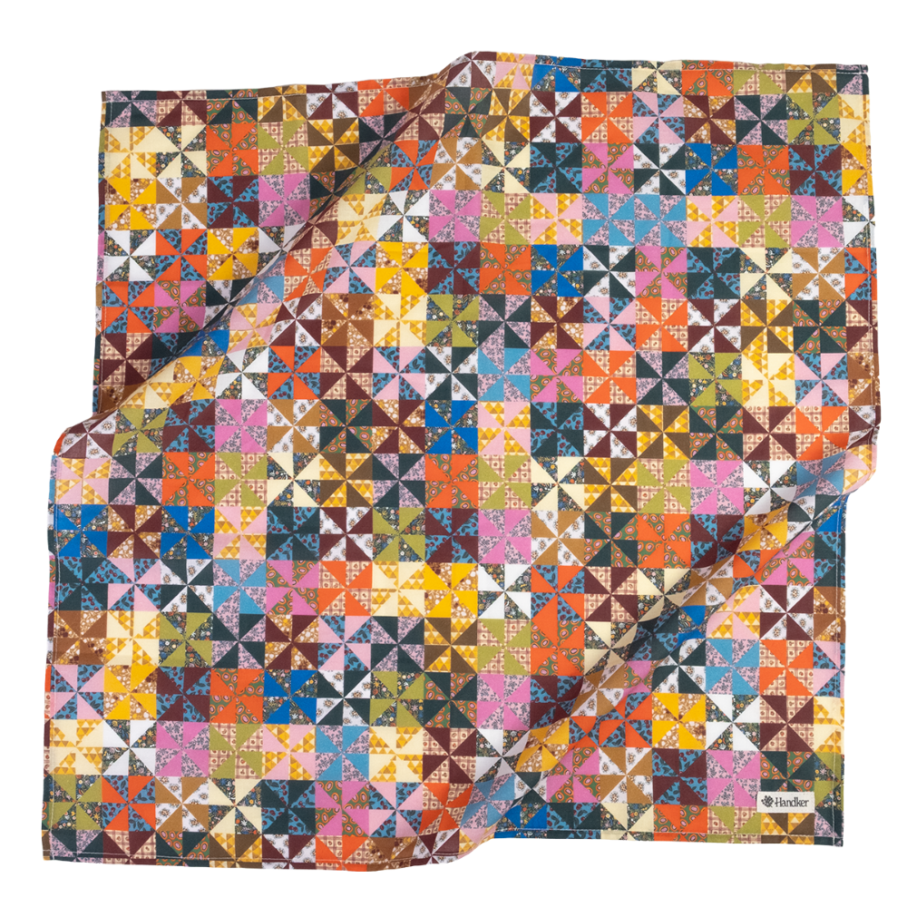 A square scarf featuring a colorful geometric patchwork pattern of triangles and squares in many shades, including pink, blue, yellow, orange, brown, green, and white. A small black label with the brand name 'Handker' is visible in the bottom right corner, set against a plain white background.