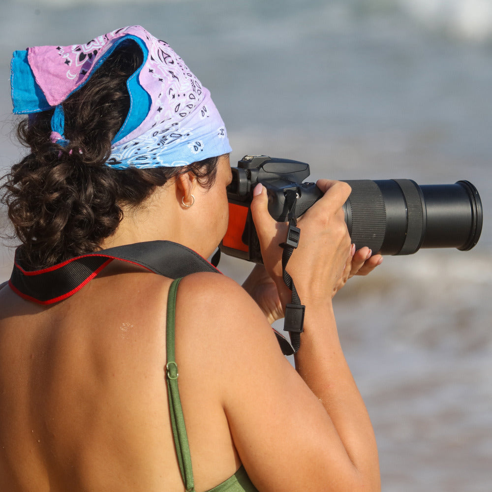 Artist photographer with a camera taking photos wearing a Cotton paisley pattern bandana as a head scarf