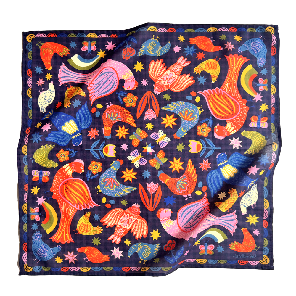A square cotton bandana featuring a vibrant folk-art style print of birds, chickens, butterflies, flowers, and stars on a dark navy blue background. The scarf is displayed flat against a clean white background, showing its subtle sheen and soft folds.