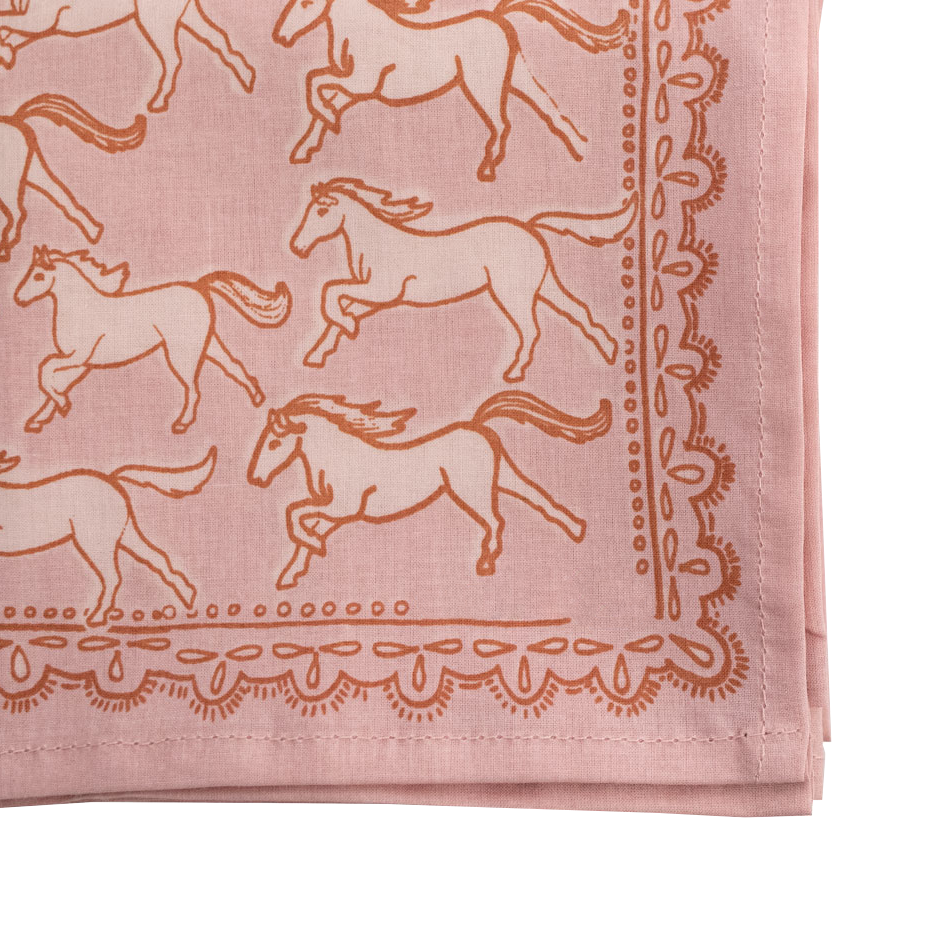 close up detail of Pink cotton bandana  with horse patterns and decorative western border