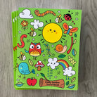 stack of green garden theme sketchbooks on a wooden floor