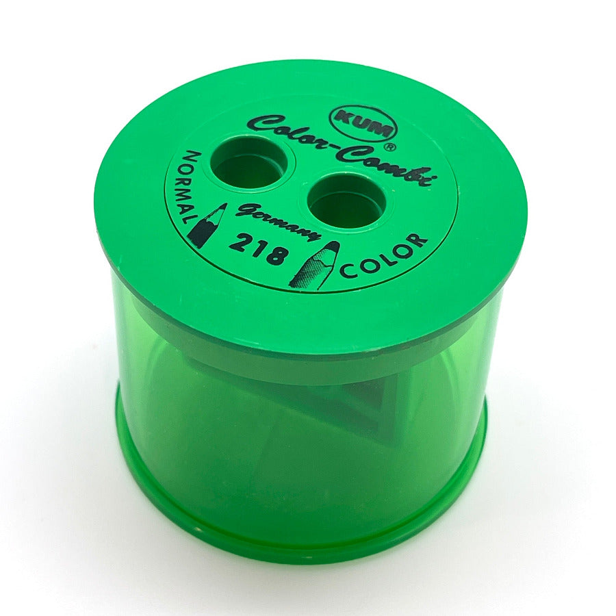 A green plastic dual-hole pencil sharpener with a translucent green body, featuring black printed text and logo on the top lid.