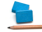 Two blue KUM erasers with a pencil on a white background