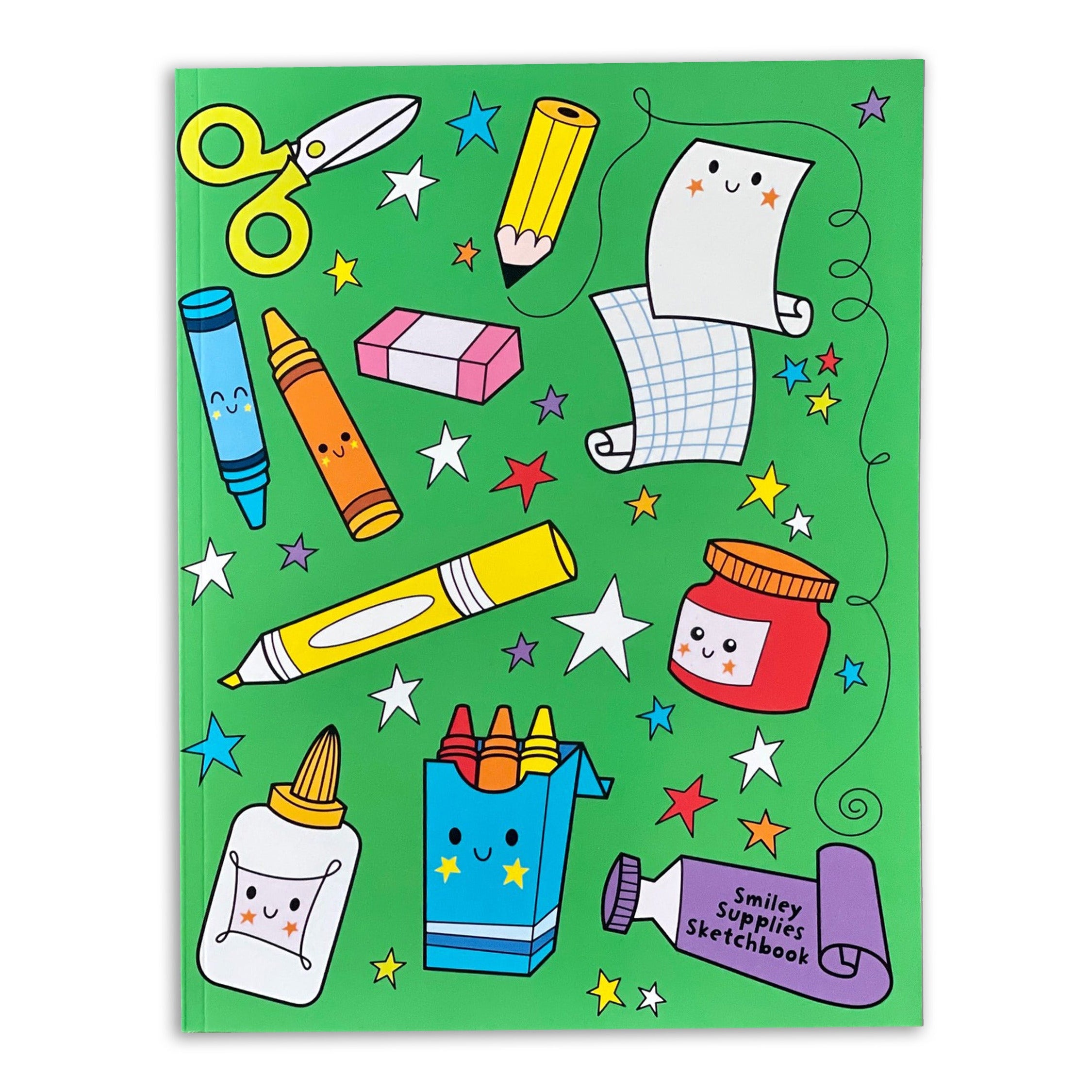 Colorful stationery items on a green sketchbook cover on white background