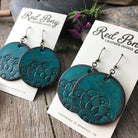 Blue leather earrings on Red Pony Leather Goods cards with a wooden background