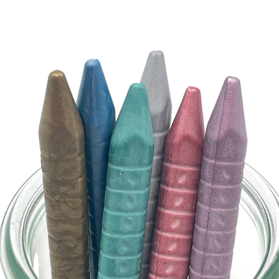 Set of 6 metallic crayons in a glass jar on a white background