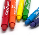 A set of six colorful silky crayons placed next to each other on a white surface.