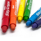 A set of six colorful silky crayons placed next to each other on a white surface.