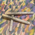 Three tubes of soaking salts French lavender scent on a colorful textured surface