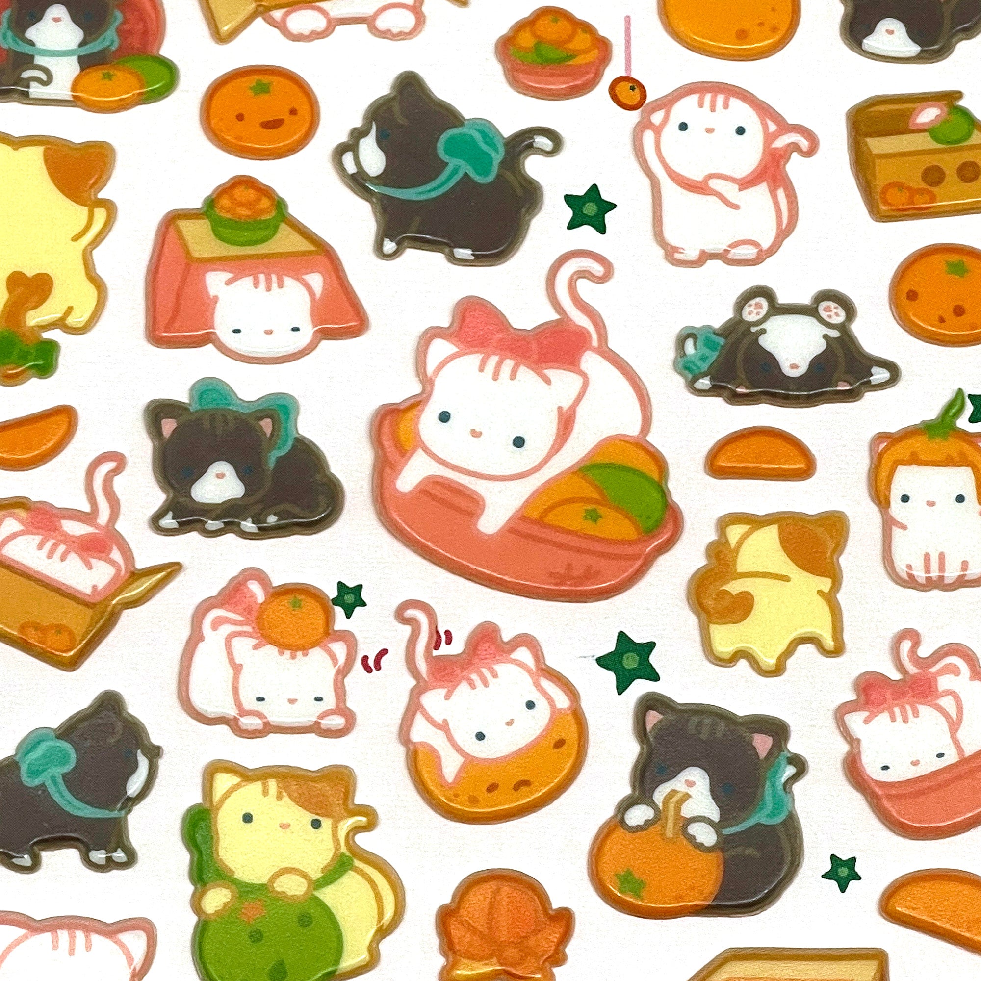 A collection of cute, orange-colored cat-themed stickers presented on a white background.