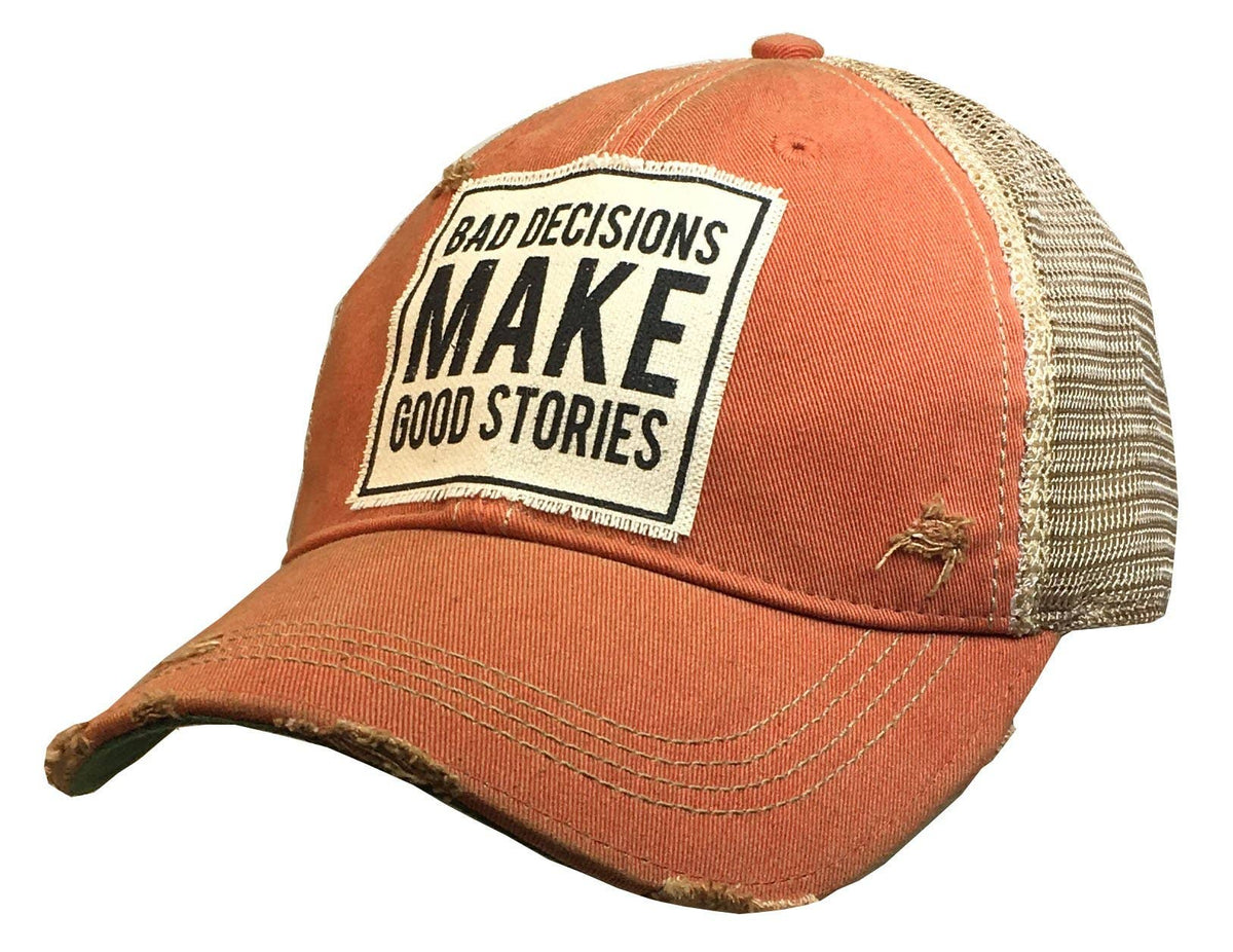 Orange cap with a mesh back and a patch that reads 'Bad decisions make good stories' on a white background.