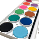 Close up detail of watercolor set for students on a white background