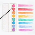 A set of metallic watercolor paints with swatches of color displayed next to a paintbrush, all arranged on a white background.