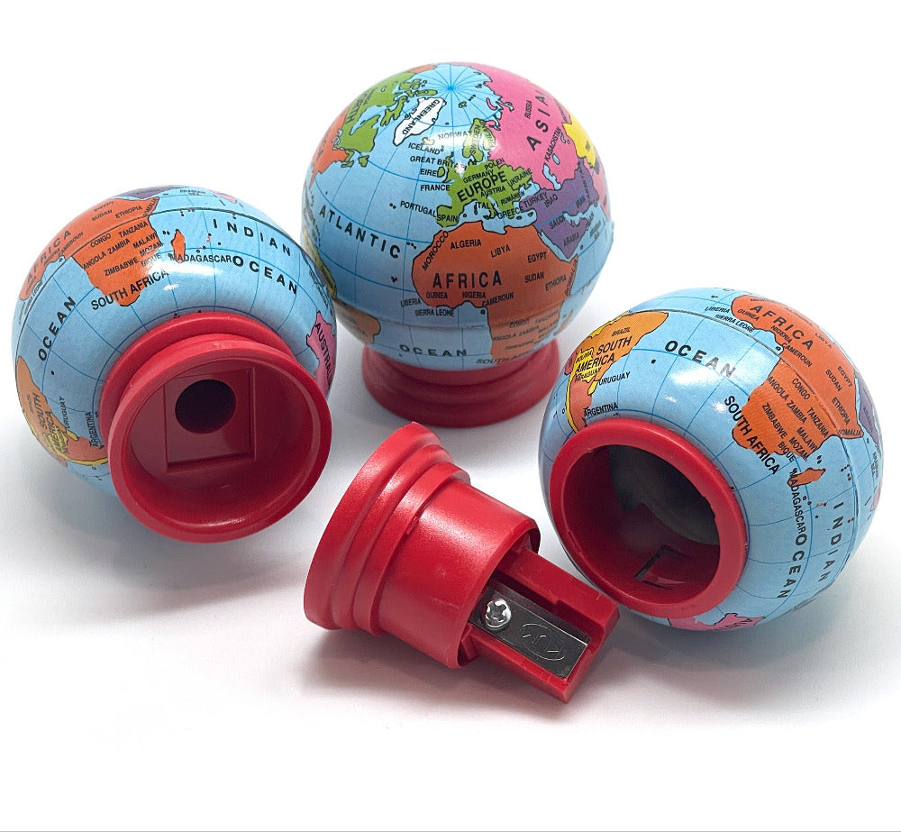Several globe-shaped pencil sharpeners with a colorful world map print and red plastic bases, shown on a white background with one open sharpener in front.