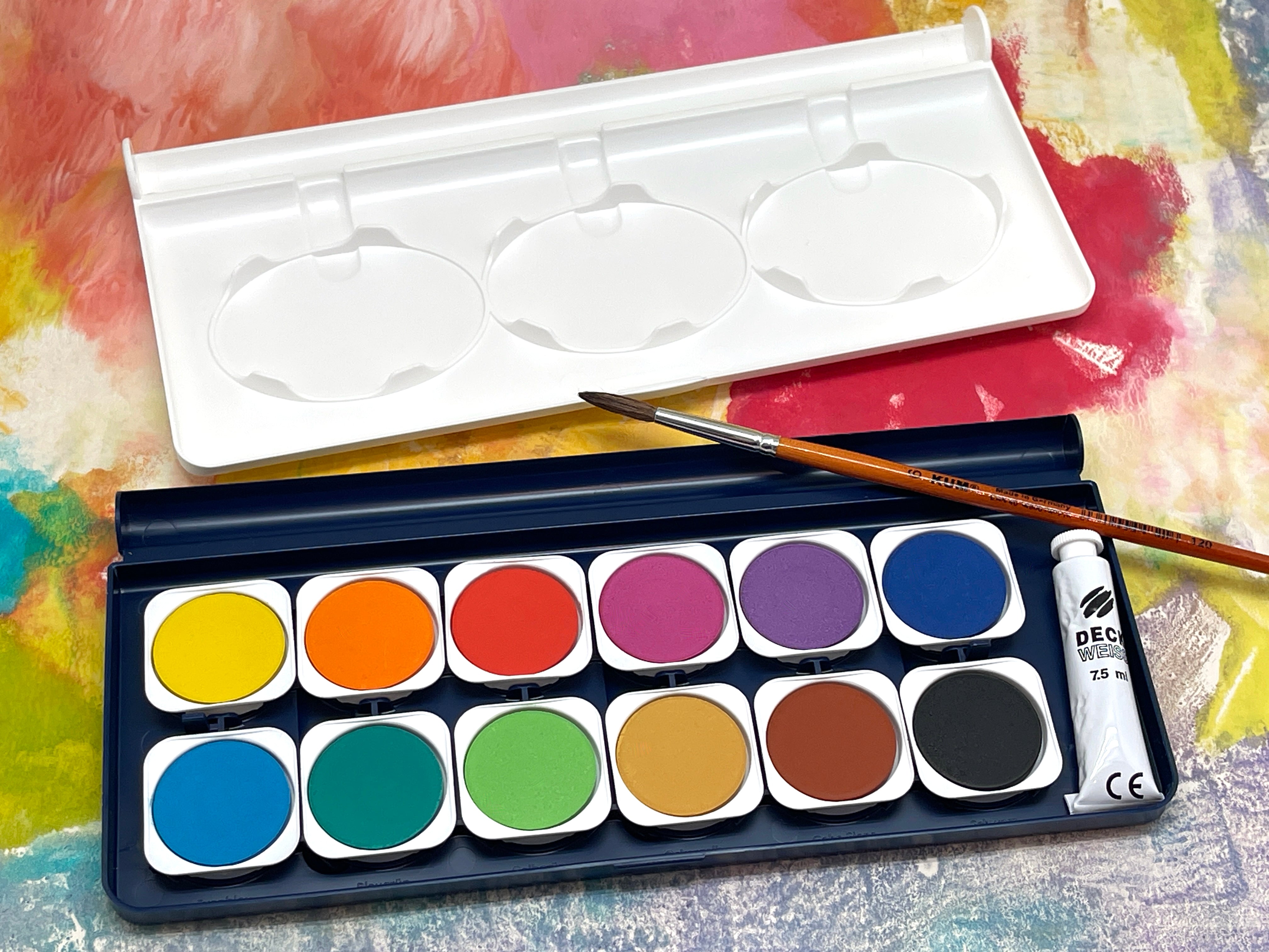 watercolor pallet on top of an original art painting background