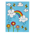 Children's sketchbook with a colorful design of a cloud, rainbow, flowers, and bees on a blue background.