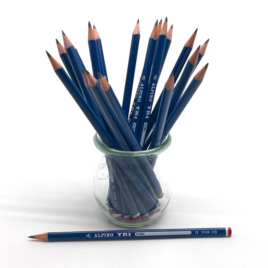 A group of blue Alpino Tri graphite pencils arranged in a small clear glass jar, with one pencil placed horizontally in front on a white background.